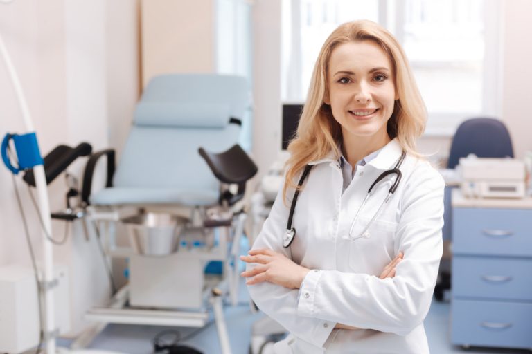 Cheerful gynecologist waiting for the next patient in the cabinet- IUD Insertion